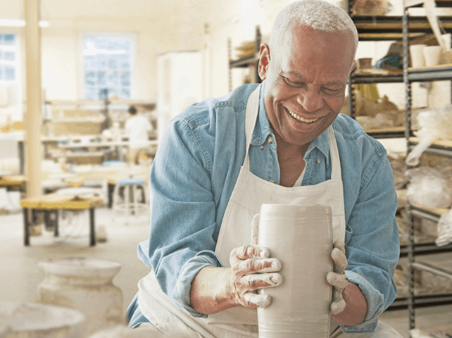 man sculpting clay