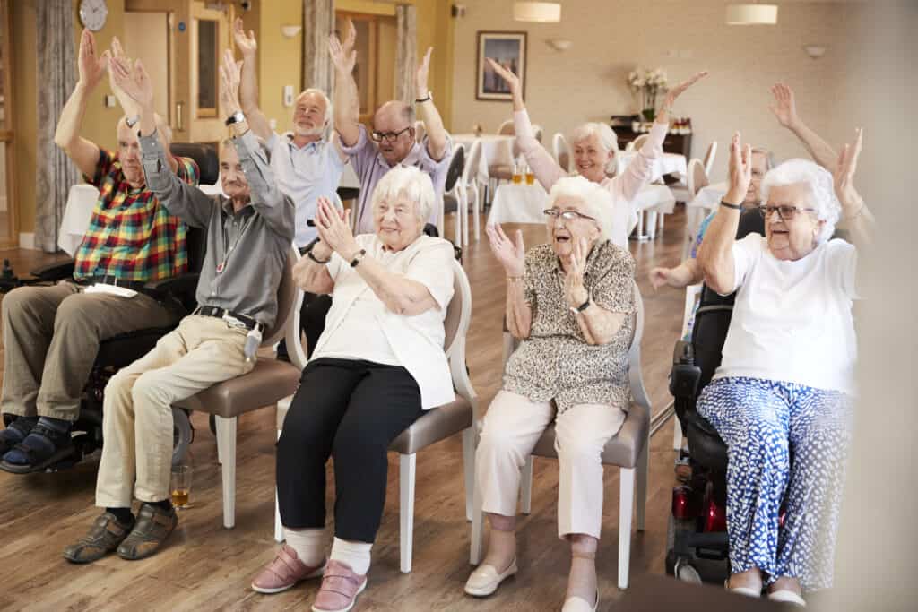 Seniors participating in a group activity in a senior living community common area.