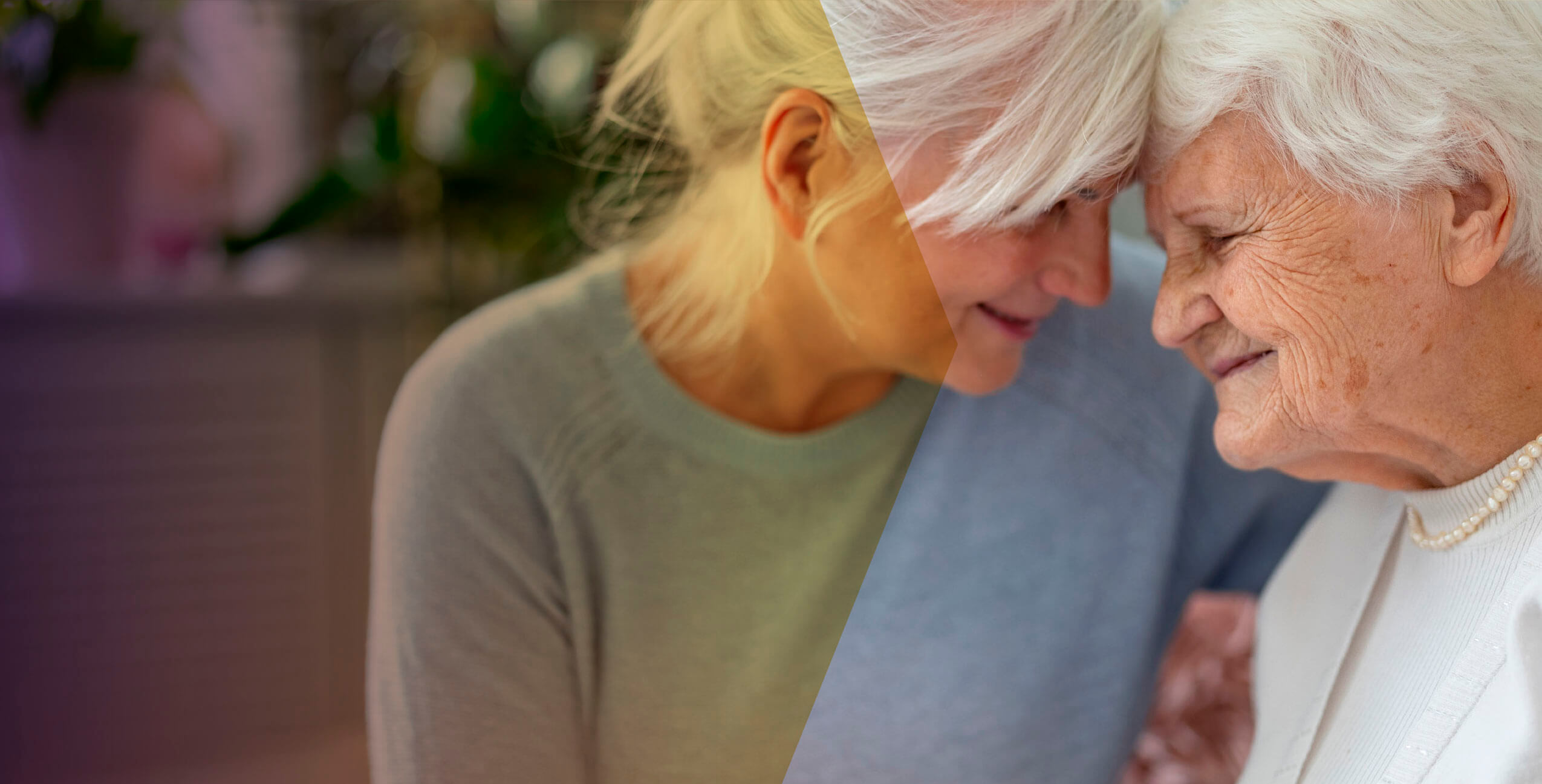 two senior women show affection through a hug