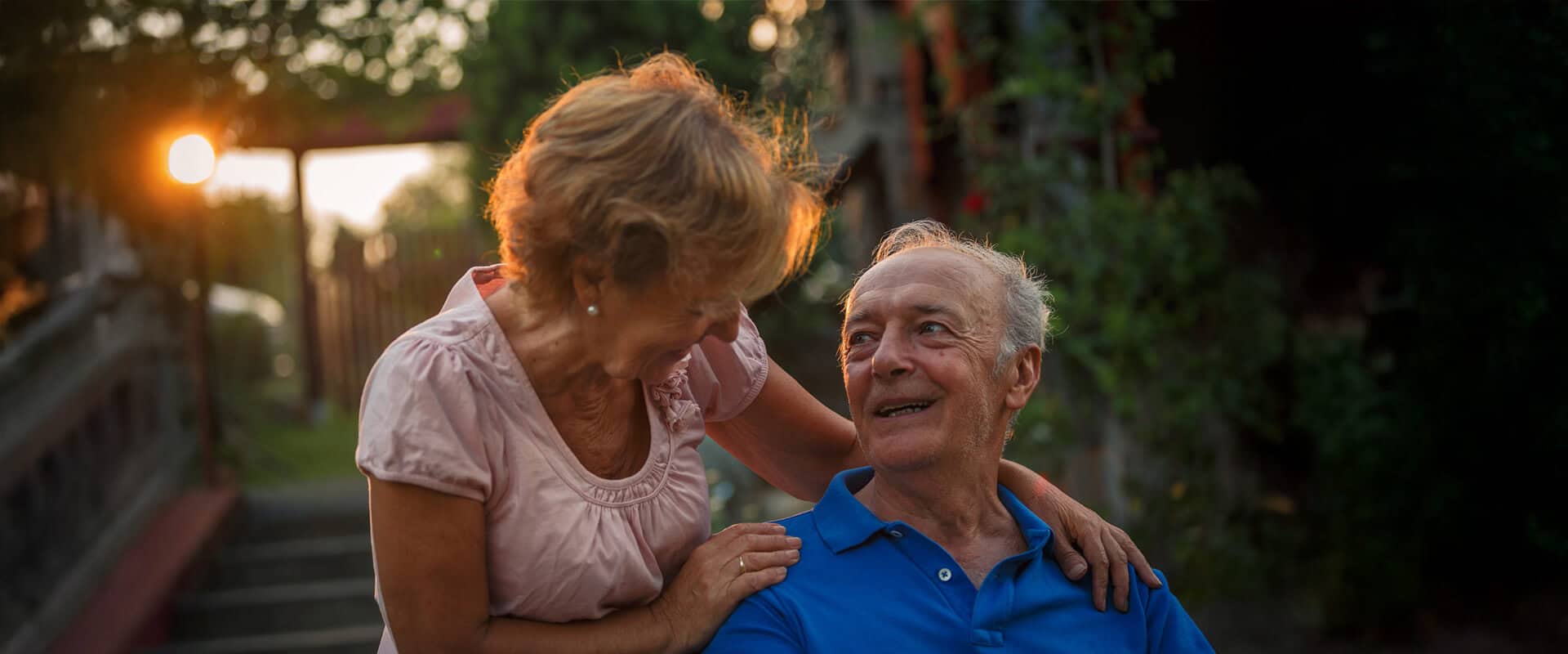 Senior couple gaze at each other during sunset